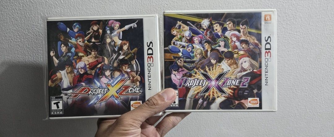 Project X Zone 1 & 2 Nintendo 3DS Games (Category: Nintendo) located in Quezon City. Submitted by essayworks (Listing ID 1460255981, Image 1). Description: - Project X Zone 1 & 2 for Nintendo 3DS - Both games come in their original cases - Exciting crossover fighting games - Features characters from Namco, Sega, and Capcom franchises - Perfect for fans and collectors - Get both for a complete gaming experience.