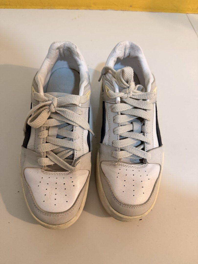 Puma White and Grey Sneakers (Category: Sneakers) located in Floridablanca. Submitted by retroretrieve (Listing ID 1460205687, Image 2). Description: - Puma Sneakers - Color: White and Grey - Size: UK 6 (EUR 39 / US 7) - Condition: Used, with visible wear on soles and edges - fits us 8 - original.