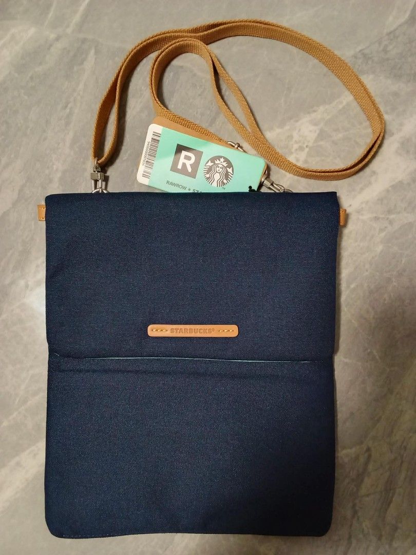 RAWROW + Starbucks Collaboration Pouch Bag with Strap (Category: Purses & Pouches) located in Manila. Submitted by cosmiccloud-9236 (Listing ID 1460209749, Image 2). Description: - Authentic RAWROW x Starbucks collaboration pouch bag - Color: Dark blue canvas - Includes a tan adjustable strap - Features iconic Starbucks logo and RAWROW branding - Ideal for carrying your daily essentials - Brand new with tag still attached.