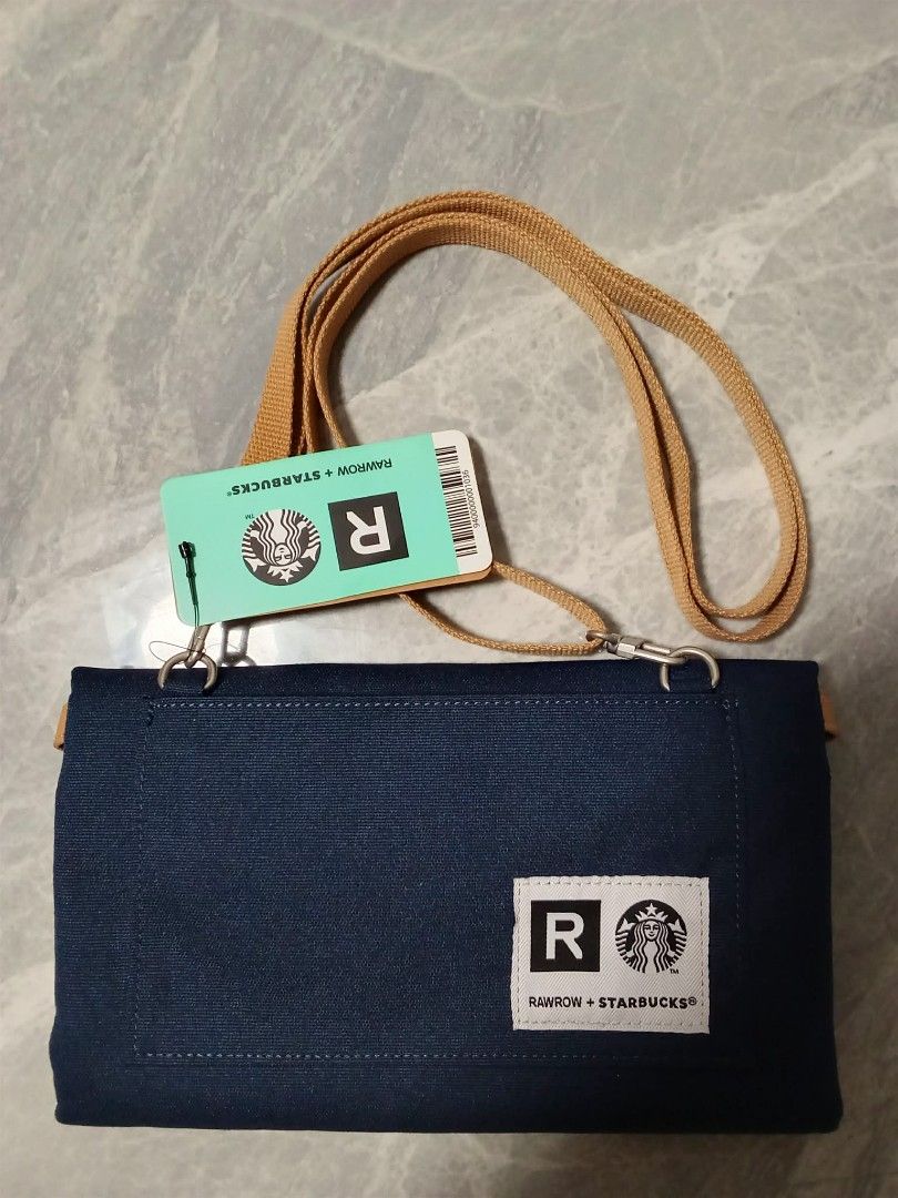 RAWROW + Starbucks Collaboration Pouch Bag with Strap (Category: Purses & Pouches) located in Manila. Submitted by cosmiccloud-9236 (Listing ID 1460209749, Image 3). Description: - Authentic RAWROW x Starbucks collaboration pouch bag - Color: Dark blue canvas - Includes a tan adjustable strap - Features iconic Starbucks logo and RAWROW branding - Ideal for carrying your daily essentials - Brand new with tag still attached.