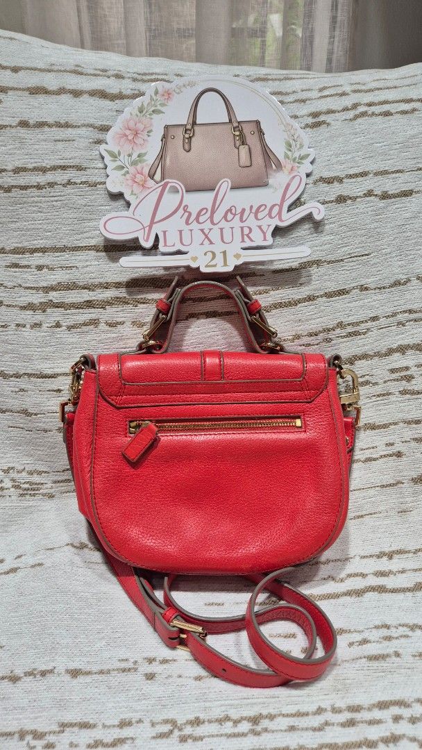 Red Leather Crossbody Bag with Gold Hardware (Category: Cross-body Bags) located in Quezon City. Submitted by prelovedluxury21 (Listing ID 1460138983, Image 3). Description: - Genuine red leather crossbody bag - Stylish buckle detail on the front flap - Elegant gold hardware accents - Convenient zipper pocket on the back - Adjustable strap for comfortable wear - Interior includes a main compartment and a smaller pocket - Ideal for everyday use an