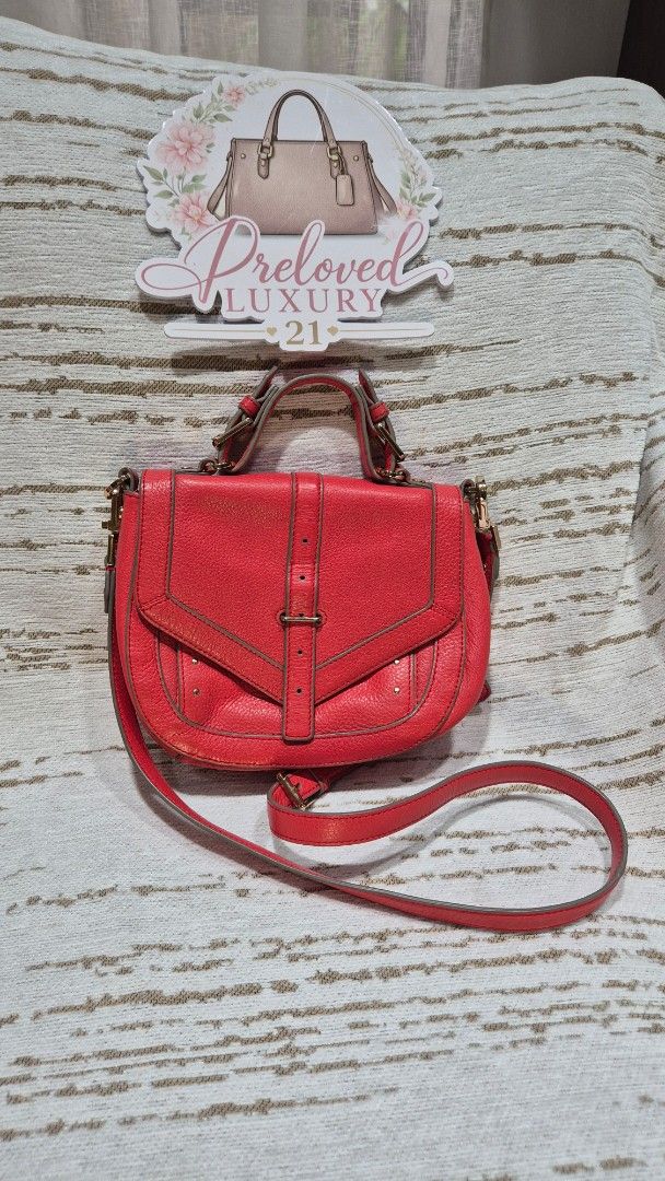 Red Leather Crossbody Bag with Gold Hardware (Category: Cross-body Bags) located in Quezon City. Submitted by prelovedluxury21 (Listing ID 1460138983, Image 1). Description: - Genuine red leather crossbody bag - Stylish buckle detail on the front flap - Elegant gold hardware accents - Convenient zipper pocket on the back - Adjustable strap for comfortable wear - Interior includes a main compartment and a smaller pocket - Ideal for everyday use an