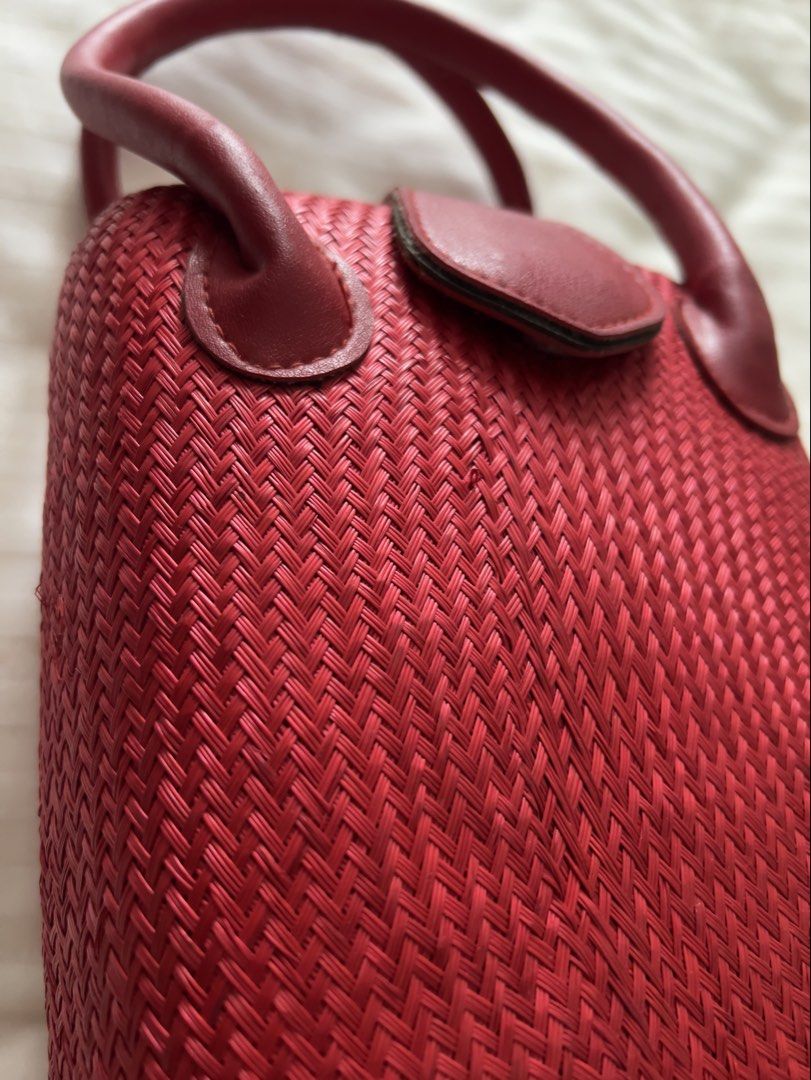 Red Woven Handbag with Leather Accents (Category: Luxury Bags & Wallets) located in Pasig City. Submitted by jenscloset86 (Listing ID 1460160738, Image 2). Description: Measurement: Height: 10” Length: 6.5” Width: 4.5” Strap: 18” - Adorable red woven handbag - Genuine leather handles - Secure leather clasp closure - Tight, textured weave - Small and compact size, ideal for essentials - Adds a vibrant pop of color to any outfit - Pre-loved and rea