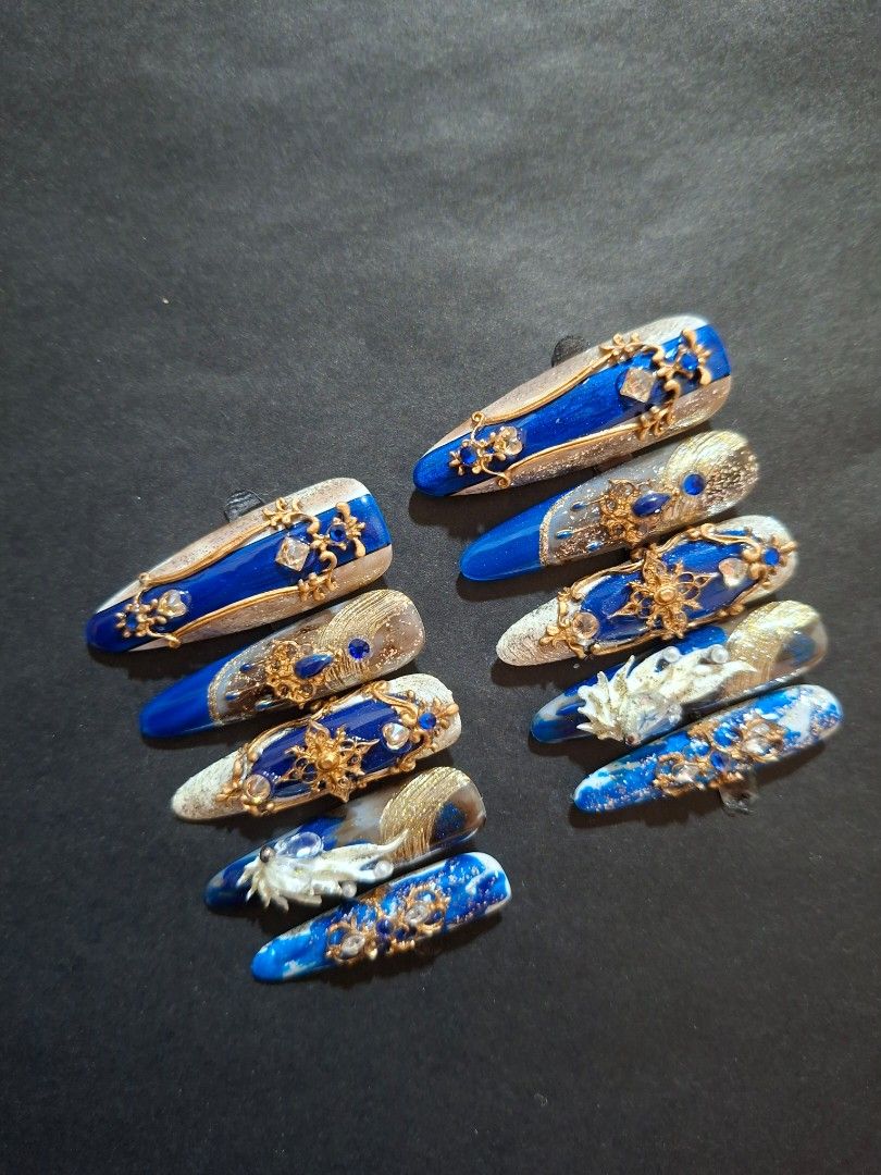 Royal Blue Press on Nails Size M (Category: Hands & Nails) located in Caloocan City. Submitted by justthings.mnl (Listing ID 1460193709, Image 2). Description: - Stunning Royal Blue press-on nails - Features intricate gold embellishments and sparkling gems - Adds a luxurious and dramatic touch to your look - Ready for immediate shipping.