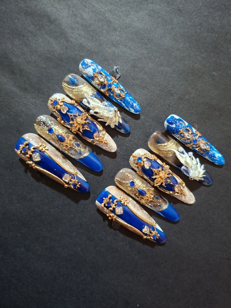 Royal Blue Press on Nails Size M (Category: Hands & Nails) located in Caloocan City. Submitted by justthings.mnl (Listing ID 1460193709, Image 3). Description: - Stunning Royal Blue press-on nails - Features intricate gold embellishments and sparkling gems - Adds a luxurious and dramatic touch to your look - Ready for immediate shipping.
