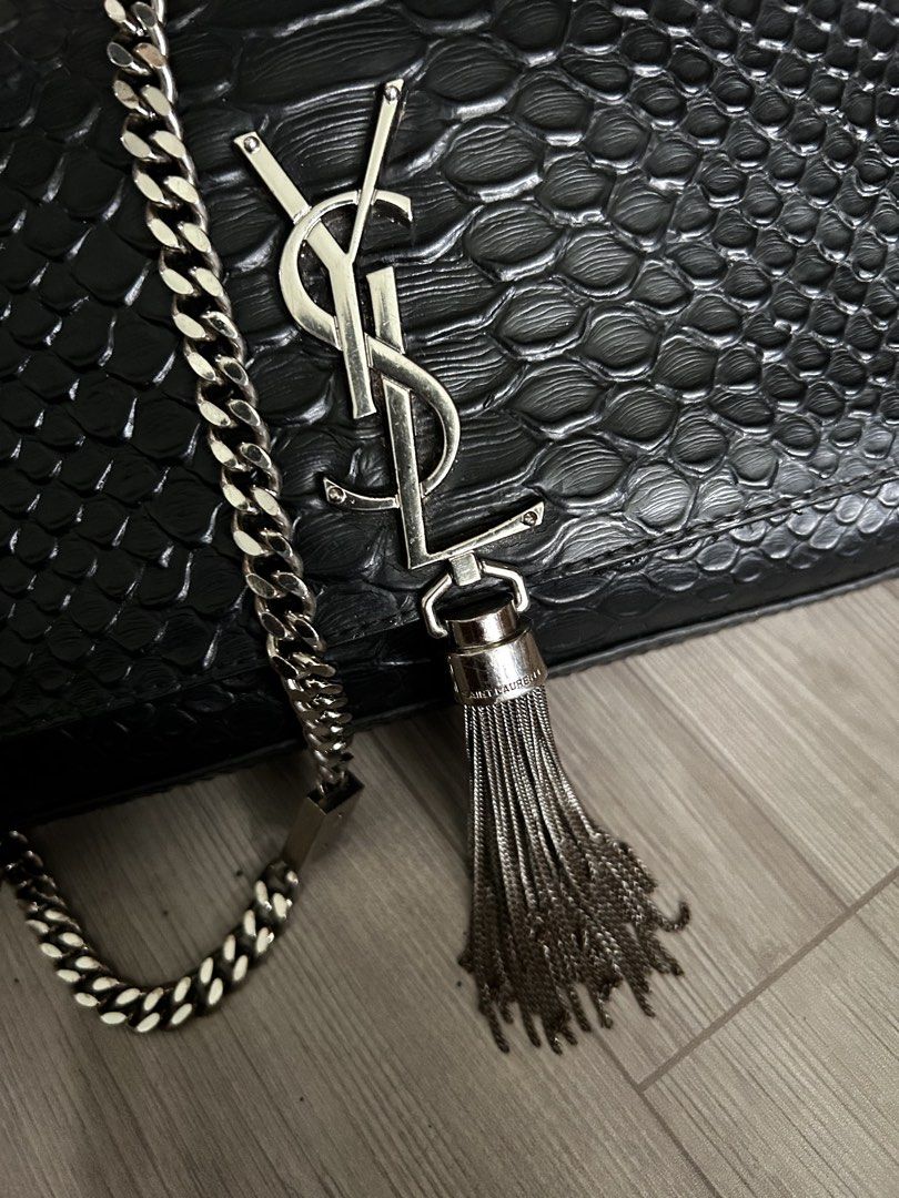 Saint Laurent (YSL) Black Python Tassel (Category: Luxury Bags & Wallets) located in Manila. Submitted by mei.zumi (Listing ID 1460135686, Image 2). Description: Coded and sourced from Japan. Planning to have it authenticated but need funds for now. So Authenticity isn’t guaranteed yet, but the look and feel are consistent with an authentic piece. Overall: Signs of use Hardware: 9/10 — Slight tarnishing only on the tassel. The chain and logo hard