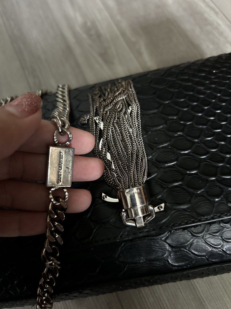 Saint Laurent (YSL) Black Python Tassel (Category: Luxury Bags & Wallets) located in Manila. Submitted by mei.zumi (Listing ID 1460135686, Image 3). Description: Coded and sourced from Japan. Planning to have it authenticated but need funds for now. So Authenticity isn’t guaranteed yet, but the look and feel are consistent with an authentic piece. Overall: Signs of use Hardware: 9/10 — Slight tarnishing only on the tassel. The chain and logo hard