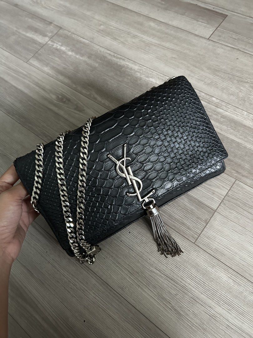 Saint Laurent (YSL) Black Python Tassel (Category: Luxury Bags & Wallets) located in Manila. Submitted by mei.zumi (Listing ID 1460135686, Image 1). Description: Coded and sourced from Japan. Planning to have it authenticated but need funds for now. So Authenticity isn’t guaranteed yet, but the look and feel are consistent with an authentic piece. Overall: Signs of use Hardware: 9/10 — Slight tarnishing only on the tassel. The chain and logo hard