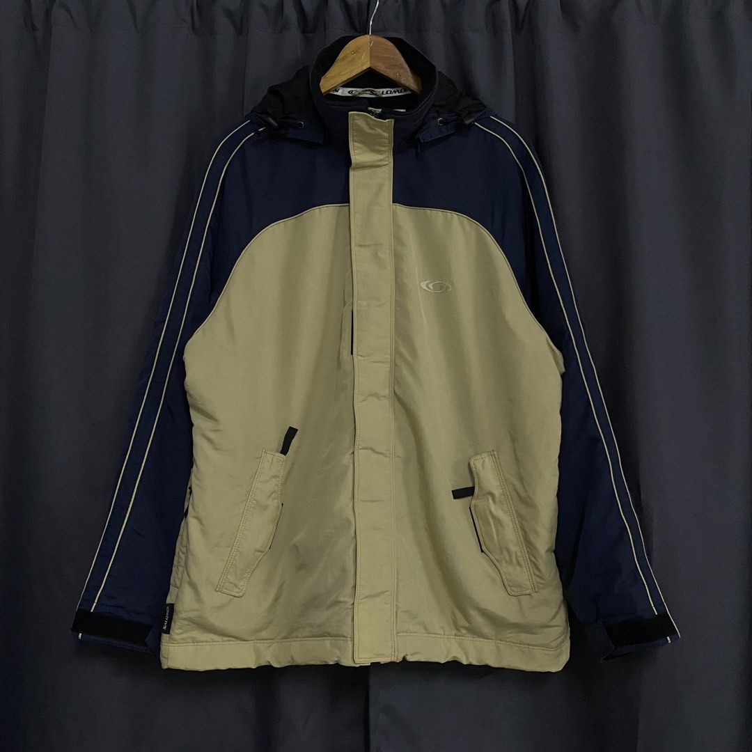 Salomon Freedom Action Sport Jacket (Category: Coats, Jackets and Outerwear) located in Santa Maria. Submitted by saintarchive316 (Listing ID 1460251724, Image 1). Description: - Cool Salomon jacket - Two-tone beige and navy blue - Features a hood - Zip-up front with velcro closures - Two front pockets with zip closures - Perfect for outdoor activities - Salomon logo on chest and back.