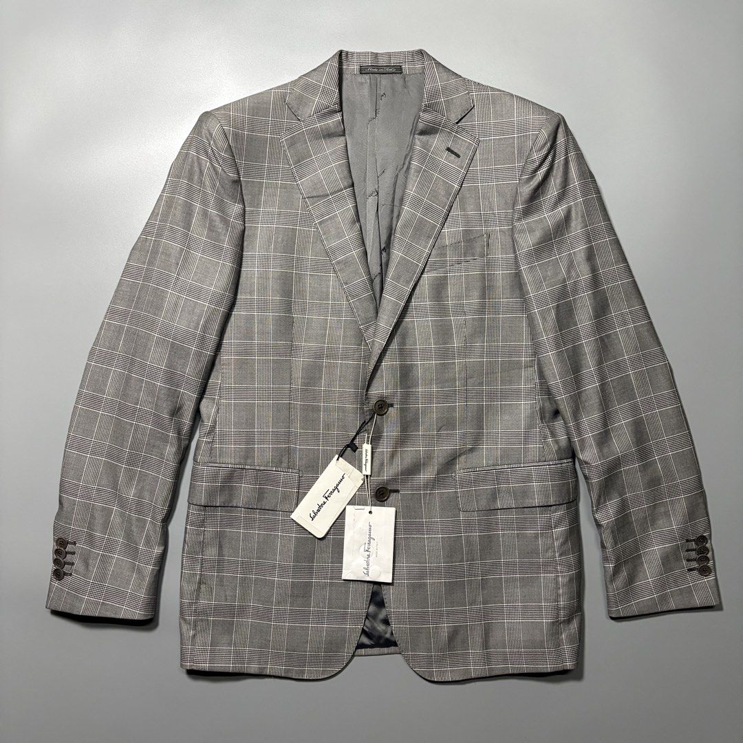 Salvatore Ferragamo Grey Plaid Wool Blazer (Category: Coats, Jackets and Outerwear) located in Tayabas. Submitted by tayabaskartell (Listing ID 1460206848, Image 1). Description: Salvatore Ferragamo Grey Plaid Wool Blazer Category: Designer / Luxury / Tailoring Material: Shell: 100% Wool Lining: 100% Cupro Description Salvatore Ferragamo tailored blazer featuring a classic grey plaid pattern and structured silhouette. The jacket retains its origi