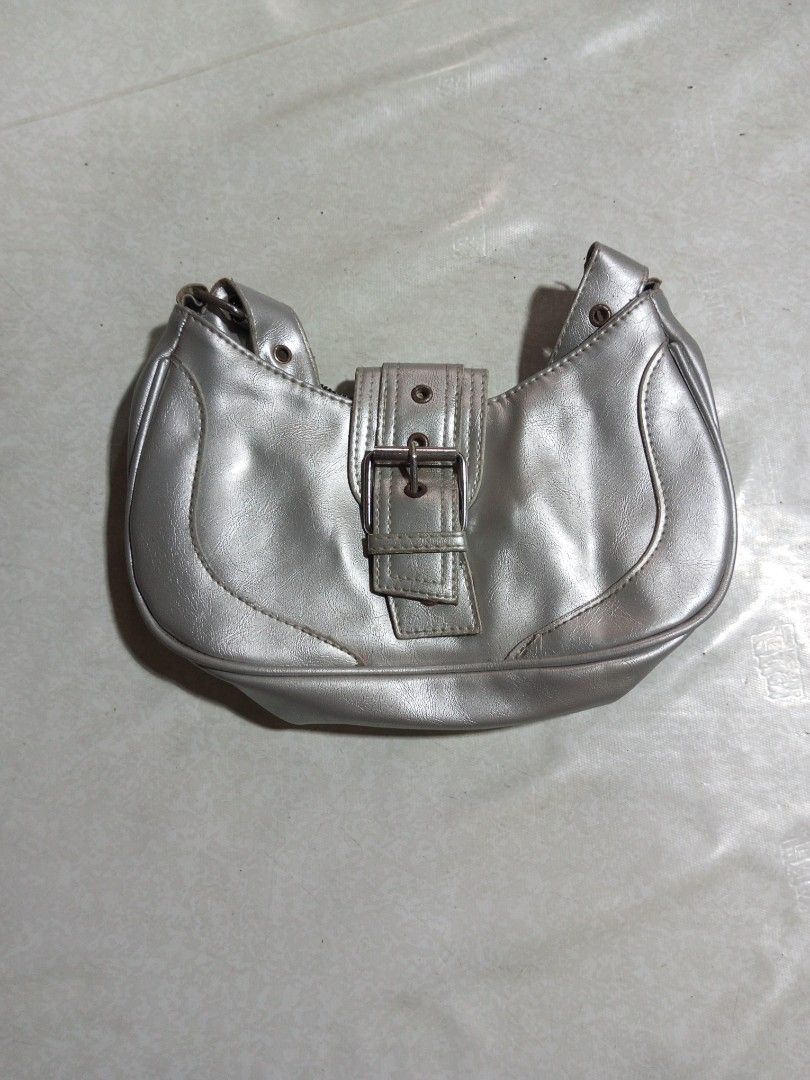 Silver Shoulder Bag with Buckle Detail (Category: Shoulder Bags) located in Malolos. Submitted by radapostol (Listing ID 1460163166, Image 1). Description: - Cute silver shoulder bag - Slight sheen material - Buckle closure on front flap - Strap attached with metal rings - Good size for essentials - Great for casual outings.