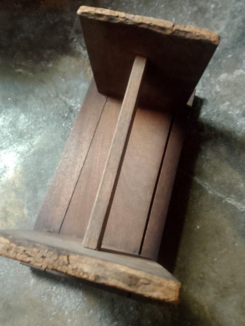 Solid Wood Stool - Rustic Design (Category: Chairs) located in Simpang. Submitted by desoul8867 (Listing ID 1460279230, Image 2). Description: - Handmade wooden stool - Natural wood grain visible - Sturdy and simple design - Versatile: use as a seat or small side table - Shows minor signs of wear, adding character - Ideal for rustic or farmhouse decor.