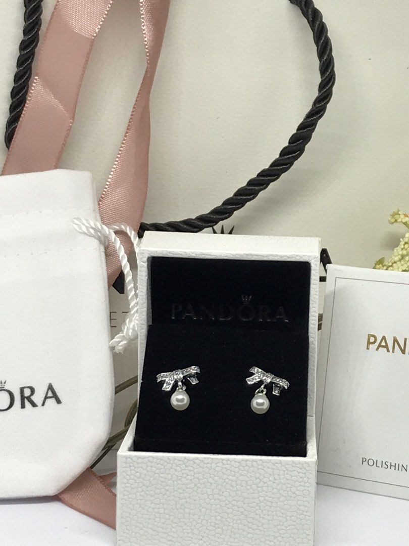 Sparkling Bow Pearl Stud Earrings (Category: Earrings) located in Manila. Submitted by Pandorahope_30 (Listing ID 1460151579, Image 1). Description: comes with paper bag and box 7-10 working days ETA.