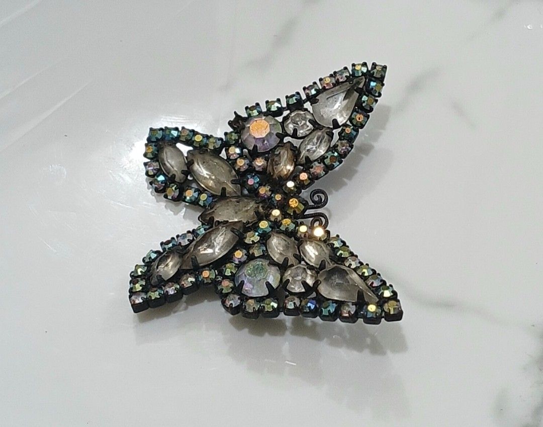 Sparkly Butterfly Brooch Rhinestone Pin (Category: Brooches) located in Bulacan. Submitted by honhonliz (Listing ID 1440600793, Image 3). Description: Sparkling butterfly brooch decorated with faceted rhinestones and iridescent accents that shimmer beautifully under light. A statement accessory perfect for coats, dresses, or bags. Elegant butterfly design Multi-faceted rhinestones with rainbow shimmer Size: 5 cm x 5 cm Preloved condition; please 