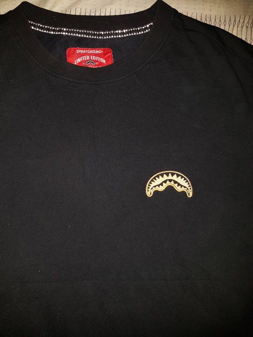 Sprayground Limited Edition Black T-Shirt (Category: Tshirts & Polo Shirts ) located in Bauang. Submitted by drie_02 (Listing ID 1460221248, Image 2). Description: - Iconic Sprayground shark mouth graphic on chest - Limited edition (tag inside) - Small Sprayground logo on back - Perfect for casual outfits.