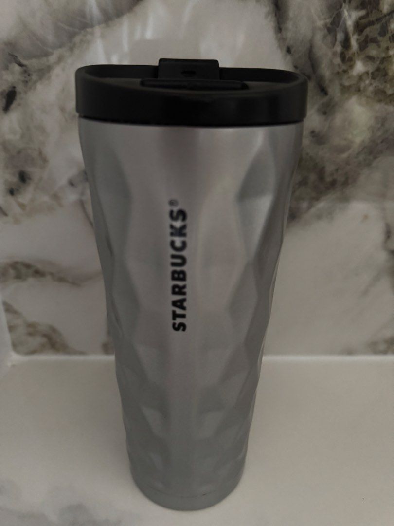 Starbucks Geometric Tumbler (Category: Water Bottles & Tumblers) located in Manila. Submitted by decluterthings888 (Listing ID 1460166813, Image 1). Description: - Sleek silver Starbucks tumbler - Features a modern geometric pattern - Black lid with convenient flip-top closure - Perfect for both hot and cold beverages - Designed for on-the-go convenience - Fits most standard cup holders - A stylish accessory for your daily drinks.