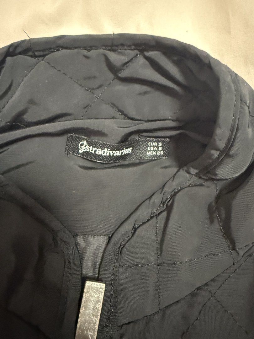 Stradivarius Quilted Jacket Black Size S (Category: Coats, Jackets and Outerwear) located in Taguig. Submitted by shayem22 (Listing ID 1460147265, Image 2). Description: - Black quilted jacket from Stradivarius - Features a zip-up front - Two convenient zip pockets - Smooth, silky interior lining - Ideal for layering and casual wear.