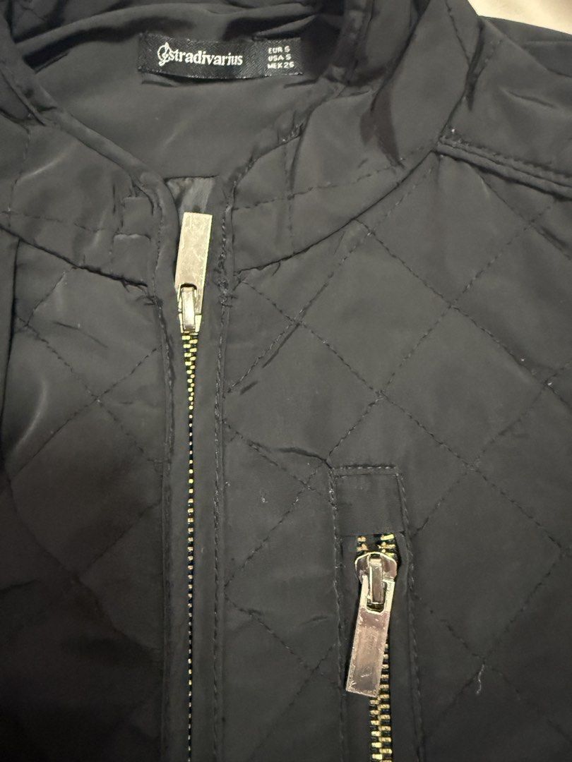 Stradivarius Quilted Jacket Black Size S (Category: Coats, Jackets and Outerwear) located in Taguig. Submitted by shayem22 (Listing ID 1460147265, Image 3). Description: - Black quilted jacket from Stradivarius - Features a zip-up front - Two convenient zip pockets - Smooth, silky interior lining - Ideal for layering and casual wear.