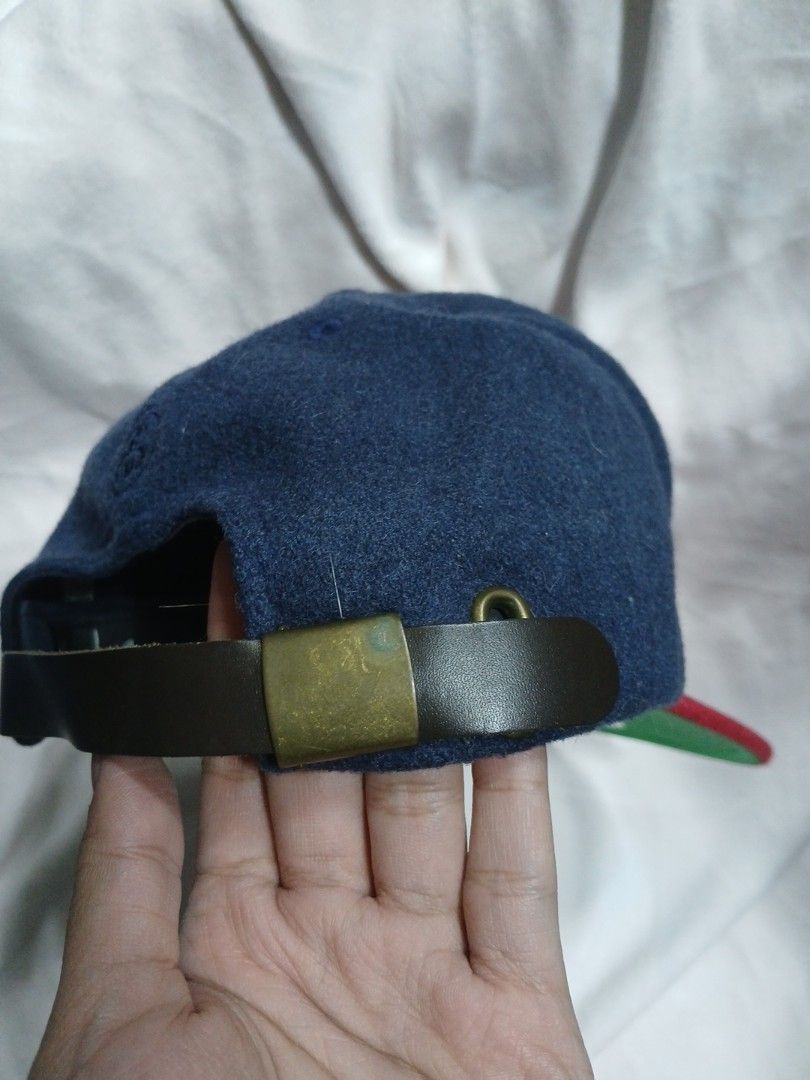 Stussy Wool Cap (Category: Caps & Hats) located in La Trinidad. Submitted by dashopperist (Listing ID 1460205548, Image 3). Description: - Classic Stussy snapback cap - Navy blue crown with red brim - White embroidered Stussy logo on front - Leather strap closure with brass hardware - Made from a wool blend material - Ideal for everyday wear.