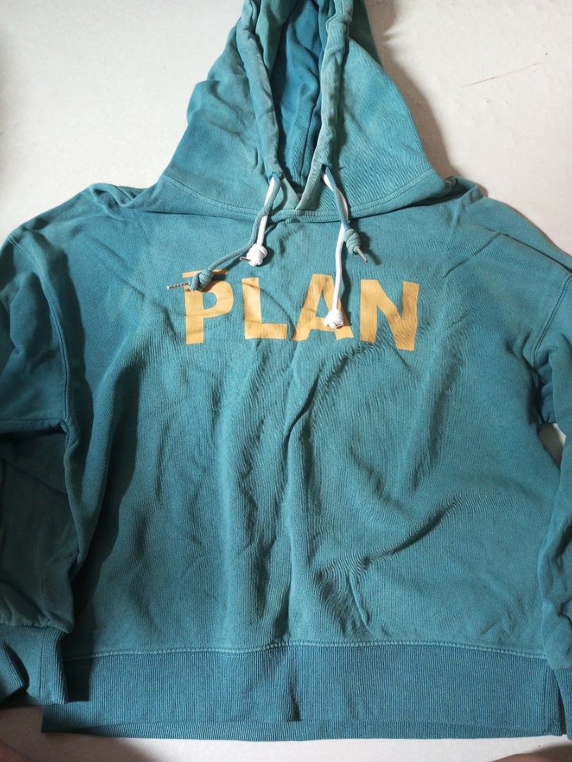Teal Hoodie with "PLAN" Graphic (Category: Hoodies) located in Malolos. Submitted by radapostol (Listing ID 1460161274, Image 1). Description: - Color: Teal - Graphic: Yellow 'PLAN' design on front - Features: Drawstring hood, front pocket - Material: Soft and comfortable fabric - Style: Ideal for casual wear.