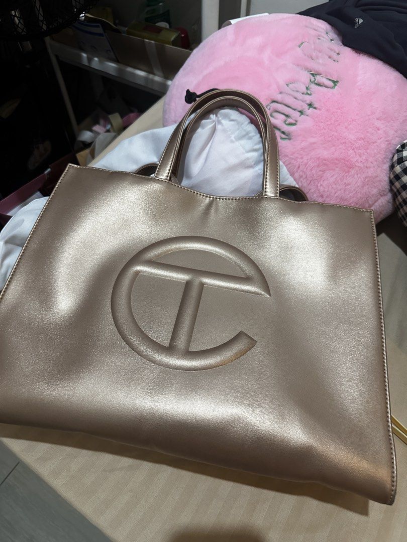 Telfar Medium Shopping Bag - Copper (Category: Tote Bags) located in Las Pinas. Submitted by stephcinco (Listing ID 1460274641, Image 1). Description: Purchased directly from Telfar in 2023 - Used a couple of times then I just placed it inside the cabinet and don’t use it anymore - Medium Telfar shopping bag - Color: Copper - Originally got it around 11k++ - Dust bag included - Some minor flaws in the lower corners of the bag, but overall the bag
