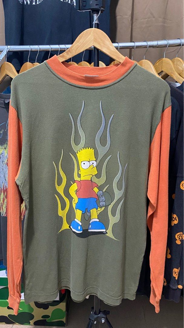The Simpsons Bart Simpson Flame Long Sleeve T-Shirt (Category: Tshirts & Polo Shirts ) located in Manila. Submitted by kowabondoc (Listing ID 1460285107, Image 1). Description: - Olive green long sleeve shirt - Contrasting orange sleeves - Large, detailed Bart Simpson graphic with flames - Classic crew neck design - Made from comfortable fabric - Ideal for any fan of The Simpsons.