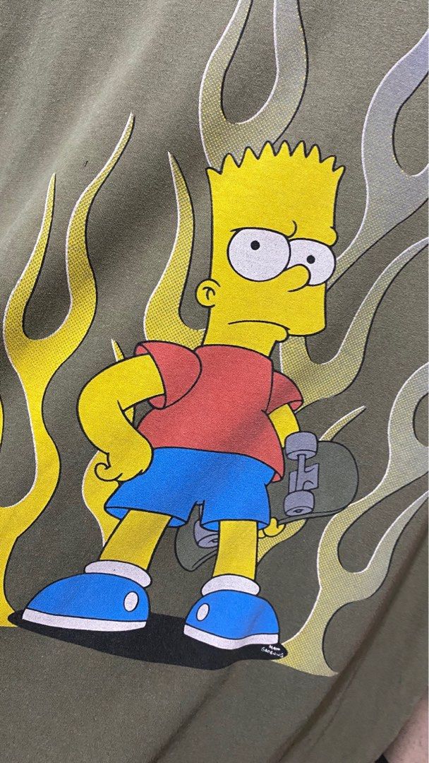 The Simpsons Bart Simpson Flame Long Sleeve T-Shirt (Category: Tshirts & Polo Shirts ) located in Manila. Submitted by kowabondoc (Listing ID 1460285107, Image 3). Description: - Olive green long sleeve shirt - Contrasting orange sleeves - Large, detailed Bart Simpson graphic with flames - Classic crew neck design - Made from comfortable fabric - Ideal for any fan of The Simpsons.