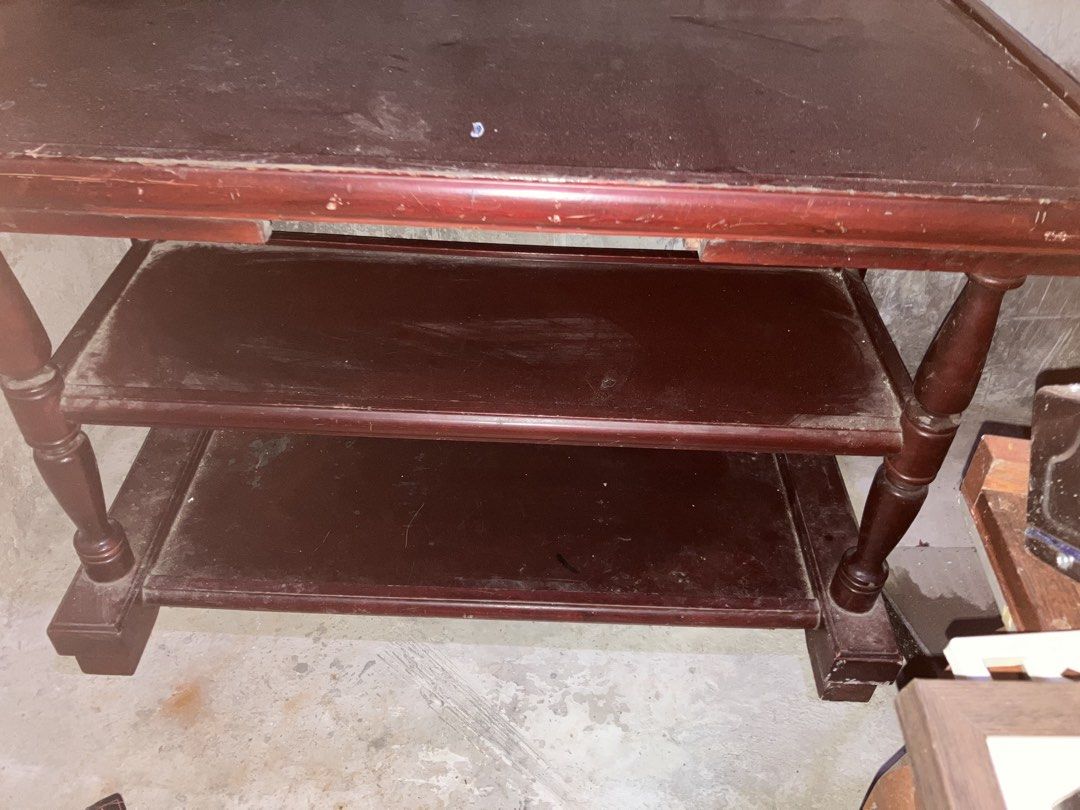 Three - tier Mahogany Side Table (Category: Tables & Sets) located in Quezon City. Submitted by ponpin (Listing ID 1460209675, Image 3). Description: - Dark red wood side table - Two lower shelves for storage/display - Turned wood legs - Top surface has visible scratches - Functional piece for any room - Requires cleaning Negotiable price PM for INFO - Sold as is.