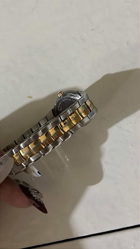 Tissot Two-Tone Watch (Category: Luxury Watches) located in Las Pinas. Submitted by hayneee (Listing ID 1460182767, Image 2). Description: - Authentic Tissot watch - Classic silver and gold two-tone band - Clean white dial with elegant gold hands - Convenient date window at the 6 o'clock position - Versatile for both everyday wear and formal events - Feel free to message me with any questions!.
