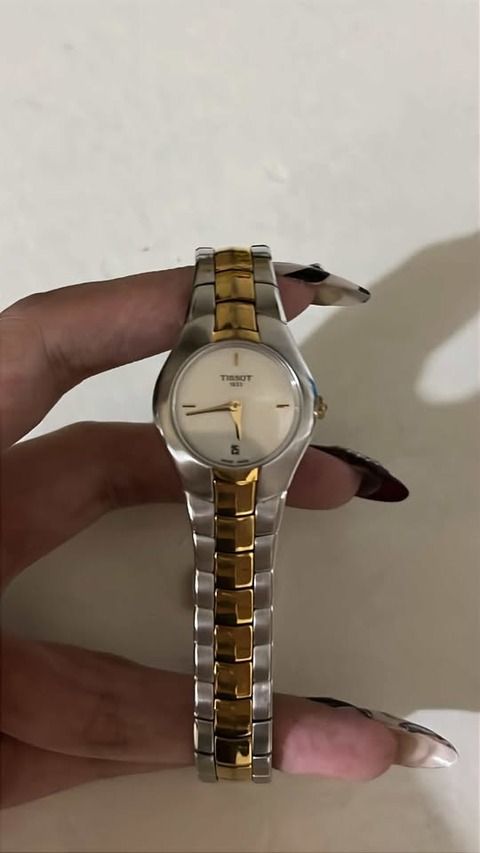 Tissot Two-Tone Watch (Category: Luxury Watches) located in Las Pinas. Submitted by hayneee (Listing ID 1460182767, Image 1). Description: - Authentic Tissot watch - Classic silver and gold two-tone band - Clean white dial with elegant gold hands - Convenient date window at the 6 o'clock position - Versatile for both everyday wear and formal events - Feel free to message me with any questions!.