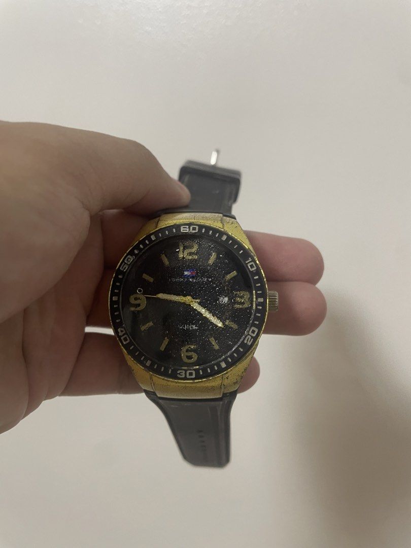 Tommy Hilfiger Watch Gold Black (Category: Women's Watches) located in Angeles City. Submitted by lukemafinds (Listing ID 1460129748, Image 1). Description: - Brand: Tommy Hilfiger - Color: Gold and Black - Strap: Rubber - Watch Face: Black with gold markers - Condition: Some signs of wear on the gold bezel - Style: Great for everyday wear -No battery, need cleaning -original -500 nalang.