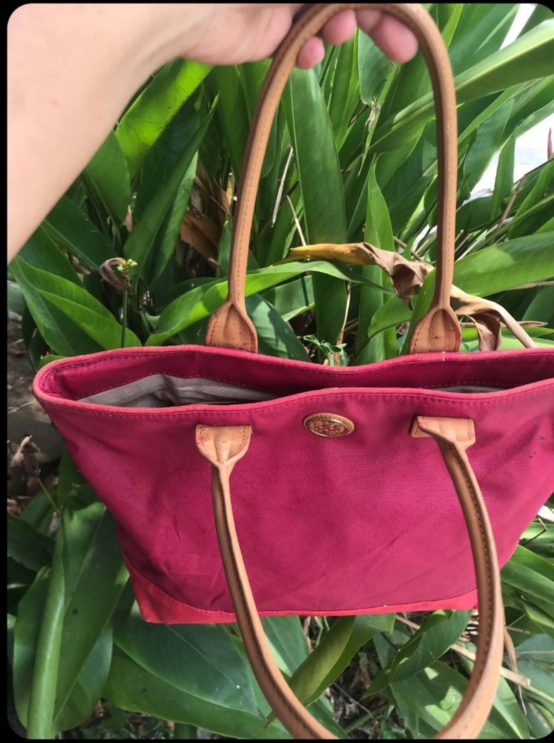 Tory Burch Canvas Tote Bag - Pink (Category: Tote Bags) located in Midsayap. Submitted by purse_gedo (Listing ID 1460304400, Image 3). Description: - Pink canvas tote bag - Tan leather handles - Features Tory Burch logo on front - Interior zippered pocket and slip pockets - Exterior canvas has marks and stains, particularly on the front - Still a functional and stylish bag.