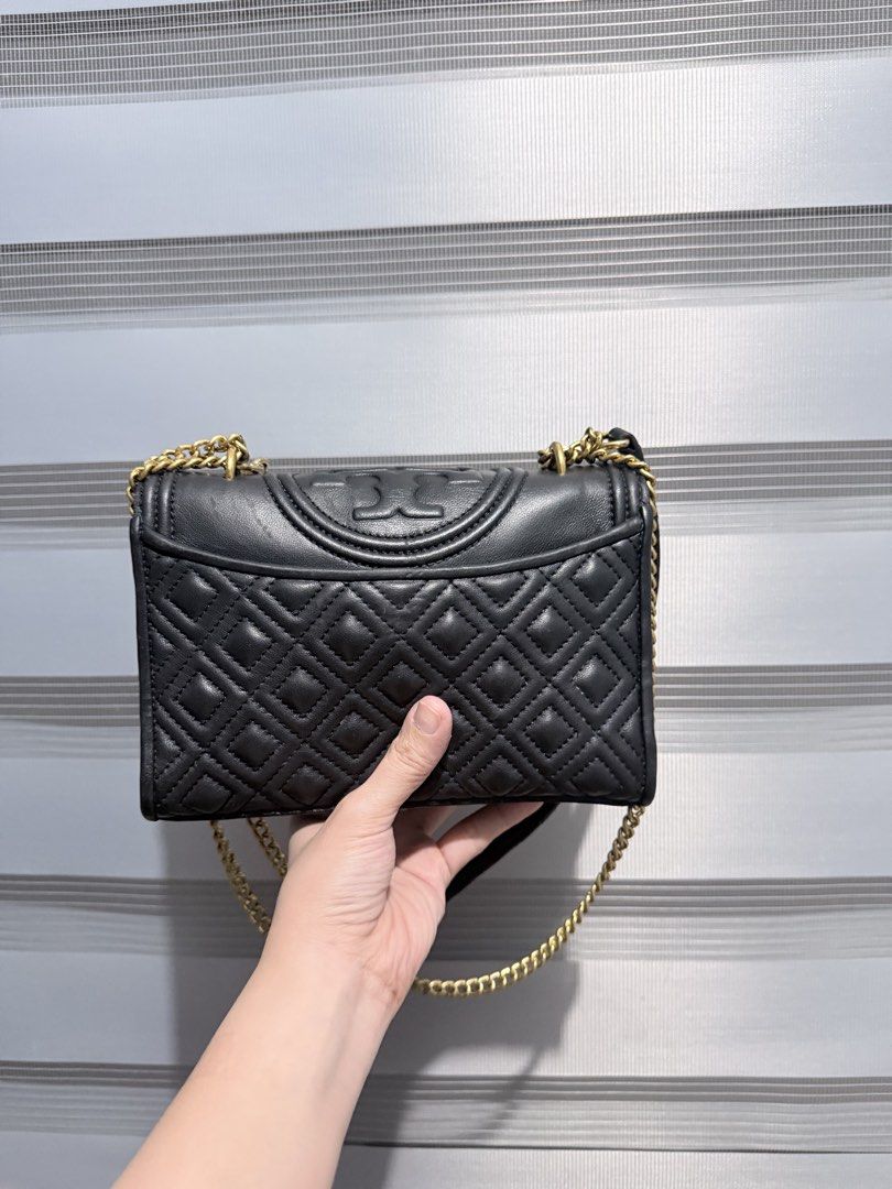 Tory Burch Fleming Convertible Shoulder Bag (Category: Luxury Bags & Wallets) located in Manila. Submitted by prelovedbygayle (Listing ID 1460272746, Image 2). Description: Material: Smooth diamond-quilted calfskin or lambskin leather. Strap: Adjustable leather and gold chain-link shoulder strap that can be worn long as a crossbody or doubled up for a shorter shoulder drop. Closure: Foldover top flap equipped with a secure magnetic snap fastening