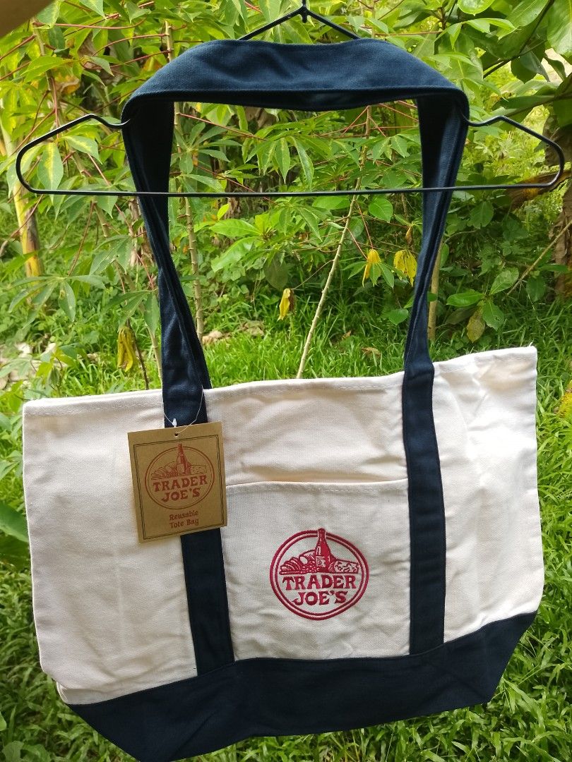 Trader Joe's Tote Bag (Large Size) (Category: Tote Bags) located in San Miguel. Submitted by skirt_girlph (Listing ID 1460231390, Image 1). Description: Brand new Trader Joe's Classic Reusable Tote Bag Factory pull-out Imported from Vietnam Size: 54 cm. x 37 cm. x 29 cm. Color: Navy blue/cream With original inside tag (see last photos) 10 pcs. available Fix Price Please note a production tolerance of 1-2 cm. may apply. Actual color may vary from 