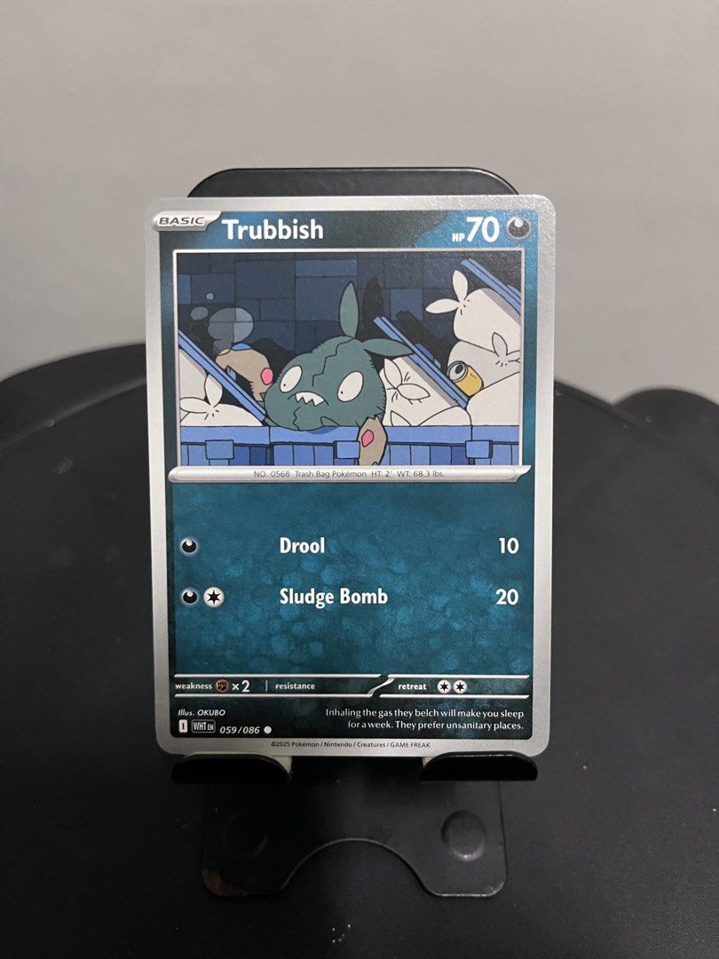 Trubbish WHT EN 059/086 Pokemon Card (Category: Raw Singles) located in Pasay City. Submitted by paullimerized (Listing ID 1460298303, Image 1). Description: - Pokemon Card: Trubbish (WHT EN 059/086) - HP: 70 - Attacks: - Drool: 10 damage - Sludge Bomb: 20 damage - Weakness: x2 - Resistance: None - Retreat Cost: 2 Colorless Energy.