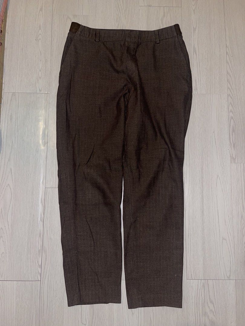Uniqlo Herringbone Smart Ankle Pants - Size Large (Category: Other Bottoms) located in San Juan City. Submitted by shop.wels (Listing ID 1460132299, Image 2). Description: Uniqlo smart ankle pants in dark brown. Features a subtle herringbone texture and a tapered-leg silhouette. Side pockets and elasticized back waist for comfort. Great for a smart-casual look. Waist measures 69-75 cm, hips 94-100 cm, and length is 35 inches. Best fits a 27-29 in
