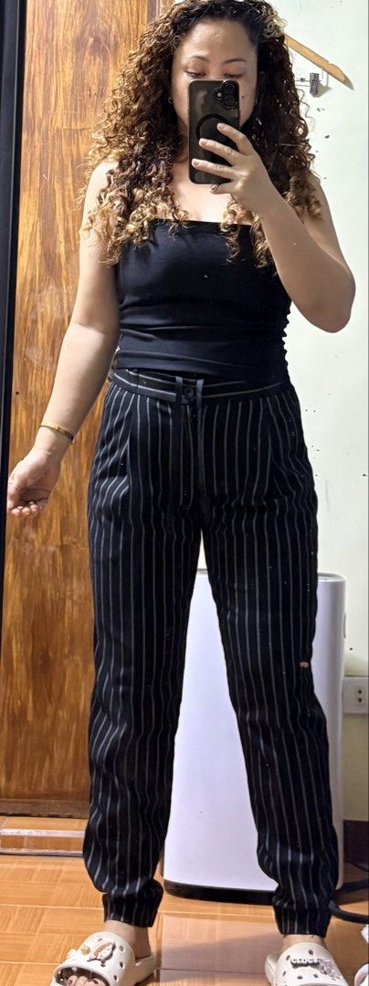 Uniqlo Striped Cropped Pants (Category: Other Bottoms) located in Paete. Submitted by skydruemadison (Listing ID 1460255146, Image 2). Description: - Black pants with white pinstripes - Cropped length - Drawstring waist with elastic waistband for comfort - Front and back pockets - Versatile for casual and smart-casual outfits - Easy to pair with various tops 26-30 L-36.5.