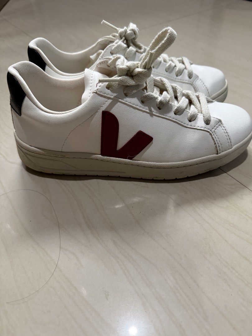 Veja Shoes (Category: Sneakers) located in Makati City. Submitted by francine04 (Listing ID 1460231230, Image 2). Description: - Classic white Veja sneakers - Iconic red 'V' logo on the side - Black heel tab with 'VEJA' branding - Light cream colored laces.