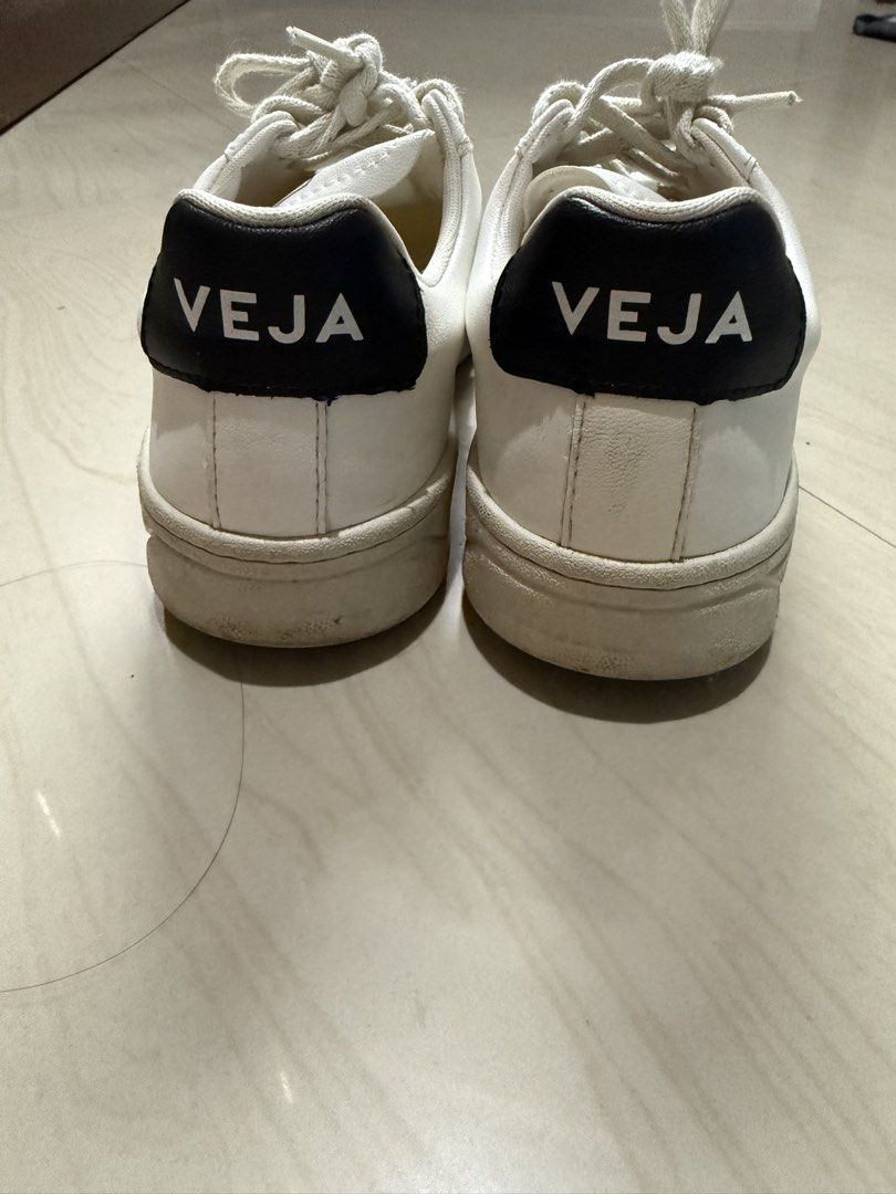 Veja Shoes (Category: Sneakers) located in Makati City. Submitted by francine04 (Listing ID 1460231230, Image 3). Description: - Classic white Veja sneakers - Iconic red 'V' logo on the side - Black heel tab with 'VEJA' branding - Light cream colored laces.