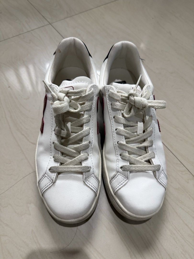 Veja Shoes (Category: Sneakers) located in Makati City. Submitted by francine04 (Listing ID 1460231230, Image 1). Description: - Classic white Veja sneakers - Iconic red 'V' logo on the side - Black heel tab with 'VEJA' branding - Light cream colored laces.