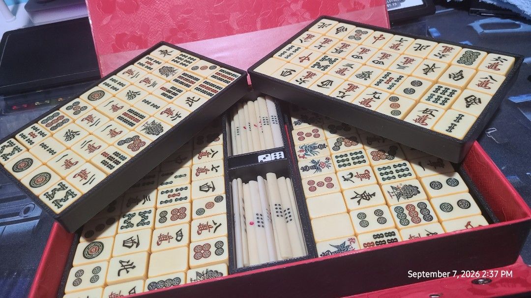 Vintage Mahjong Set with Case (Category: Board Games & Puzzles) located in Cabuyao City. Submitted by daniel.clyde86 (Listing ID 1460182513, Image 2). Description: - Complete Mahjong set - Red and black carrying case with handle - Includes all tiles with Chinese characters and images - Comes with dice - Ideal for game nights - Sold as is.