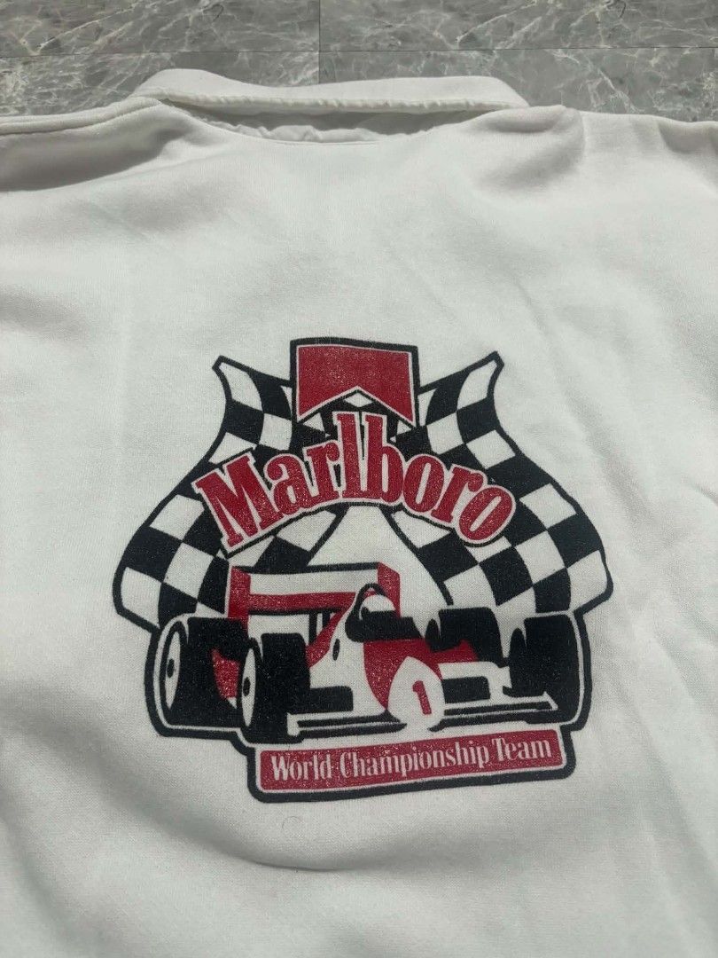Vintage Marlbor0 World Championship Jacket (Category: Coats, Jackets and Outerwear) located in Baguio. Submitted by chr0m3_h3arts (Listing ID 1460287478, Image 1). Description: Vintage Marlboro World Championship Jacket (KING LOUIE TAG) M on Tag With side pockets Dimes: Width: 21 inches Length: 27 inches Issue: Small Black Stains / Small Tear on Shoulder 🏷700.