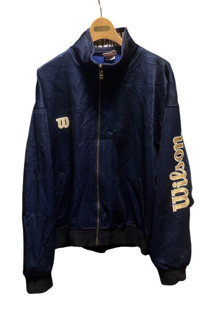 Vintage Wilson Chicago USA Track Jacket (Category: Coats, Jackets and Outerwear) located in San Pedro. Submitted by lifebeginsaftercoff33 (Listing ID 1460207109, Image 3). Description: - Vintage Wilson track jacket - Can be unisex - Navy blue with Big gold embroidered logo (Sleeve) - 'Wilson Chicago U.S.A.' embroidered on collar - Zip-up front with pockets - Blue fabric lining - Ideal for casual wear or sports - Dimes: 25 x 25 in.