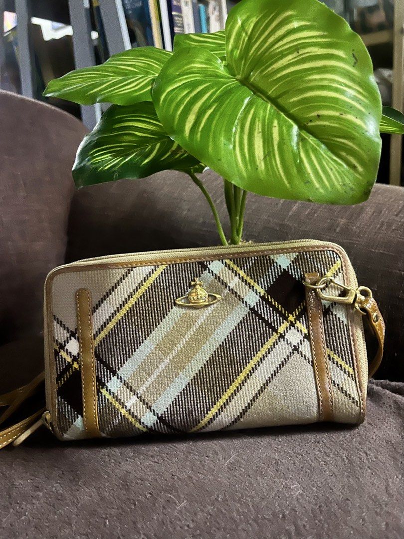 Vivienne Westwood (Category: Luxury Bags & Wallets) located in Quezon City. Submitted by retann (Listing ID 1460204533, Image 1). Description: - Authentic Vivienne Westwood wallet - Classic tartan pattern like new condition - Iconic gold orb logo - Versatile neutral tones - Secure zip closure - Convenient wrist strap - Ample interior space for cards and cash - Ideal for everyday use or travel.