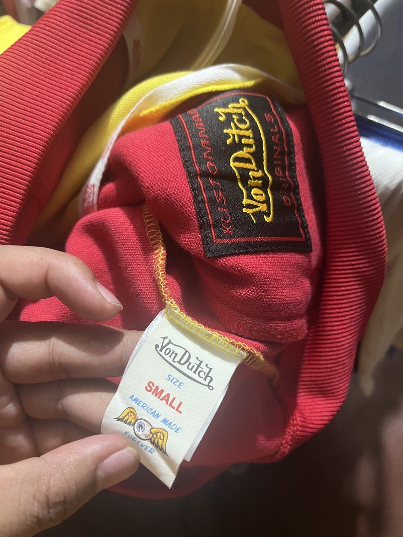 Von Dutch Track Jacket Red Yellow Size Small (Category: Coats, Jackets and Outerwear) located in Tabuk. Submitted by collectors_thrift_shop (Listing ID 1460120019, Image 2). Description: - Classic red and yellow Von Dutch track jacket - Features iconic Von Dutch logo across the chest - Zipper closure with convenient side pockets - Size: Small - Proudly American made.