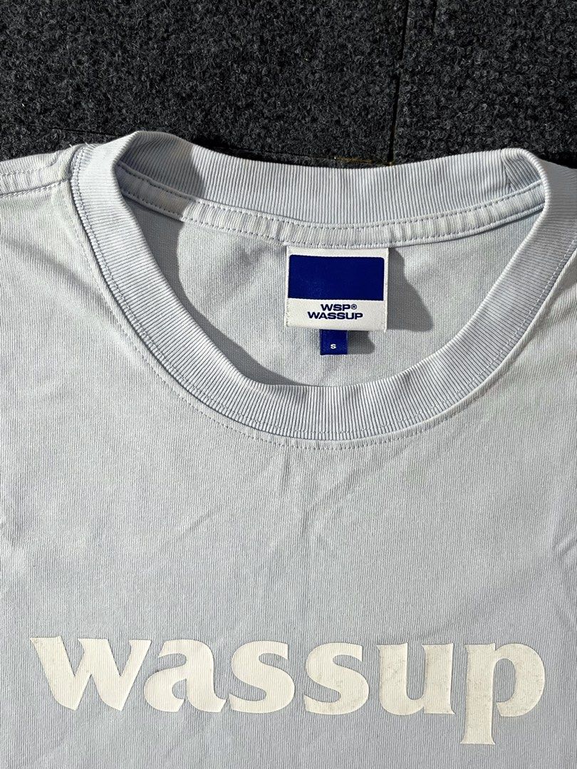 Wassup T-shirt Light Blue Size S (Category: Tshirts & Polo Shirts ) located in Los Banos. Submitted by reworn.clo2026 (Listing ID 1460113114, Image 3). Description: Size: Small (on tag) * Width: 21 * Length: 26.5 * Good condition * Issue: yellow stains.