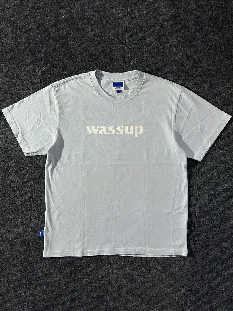 Wassup T-shirt Light Blue Size S (Category: Tshirts & Polo Shirts ) located in Los Banos. Submitted by reworn.clo2026 (Listing ID 1460113114, Image 1). Description: Size: Small (on tag) * Width: 21 * Length: 26.5 * Good condition * Issue: yellow stains.