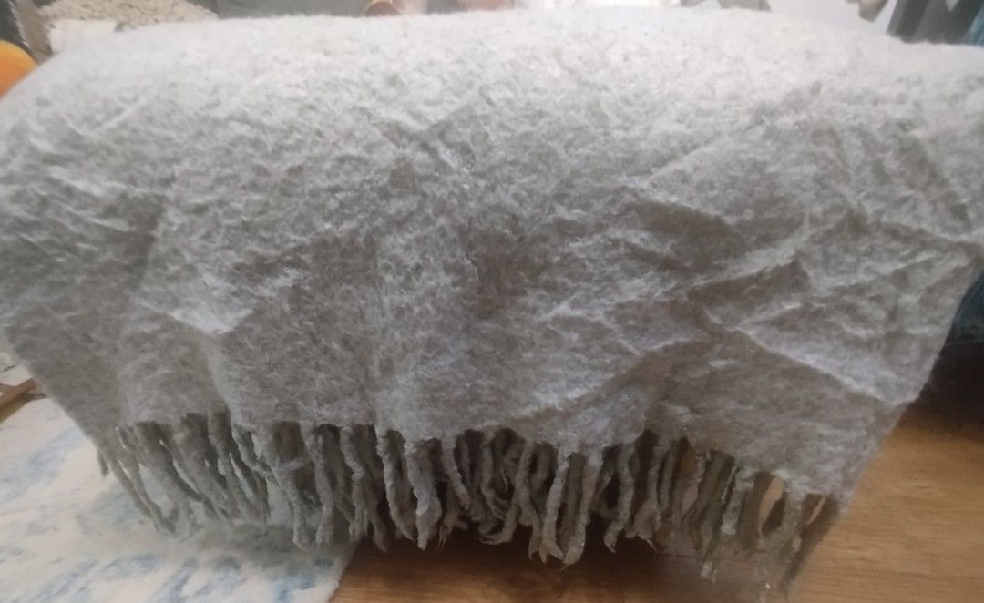 West Elm Grey Textured Throw Blanket with Fringe (Category: Bedding & Towels) located in Imus. Submitted by stop_shop7 (Listing ID 1460198120, Image 3). Description: - Cozy textured throw blanket from West Elm - Soft grey color with fringe details - Made from 100% acrylic - Dimensions: 50 x 70 inches - Perfect for adding warmth and style to your sofa or bed.