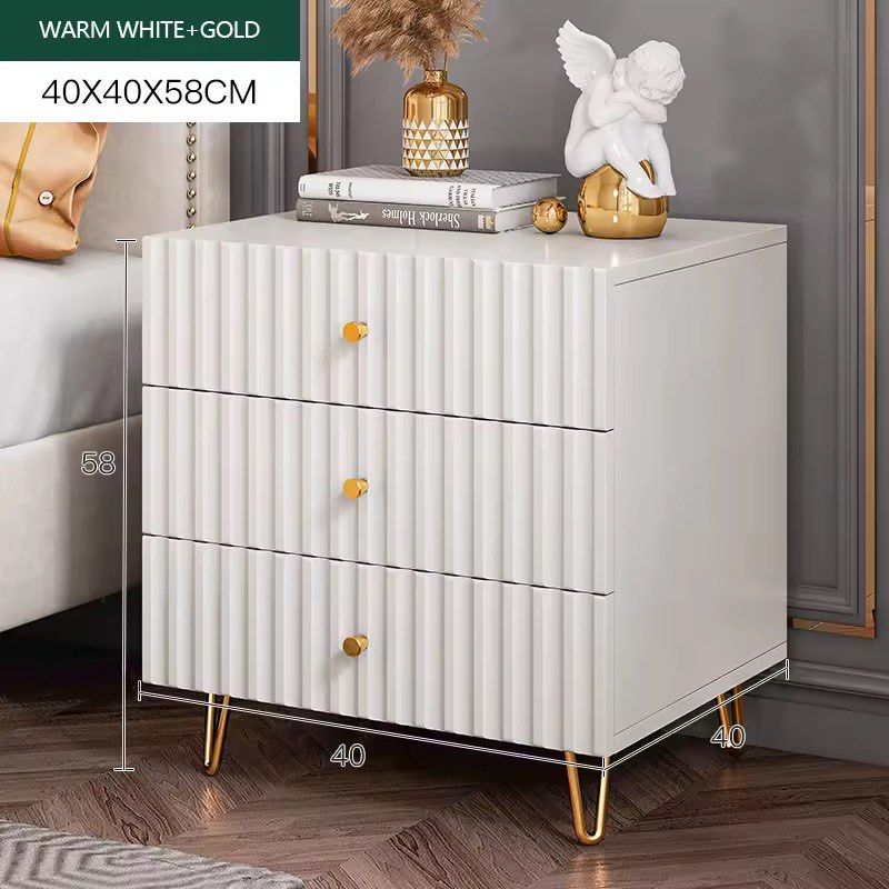 White 3-Drawer Nightstand with Gold Legs bed side table (Category: Shelves, Cabinets & Racks) located in Manila. Submitted by kristielyntan (Listing ID 1460161035, Image 3). Description: - Stylish white bedside table - Elegant gold metal legs - Unique ribbed drawer fronts - Compact size: 40x40x58cm - Ideal for storing bedside essentials - Complements most bedroom decor.