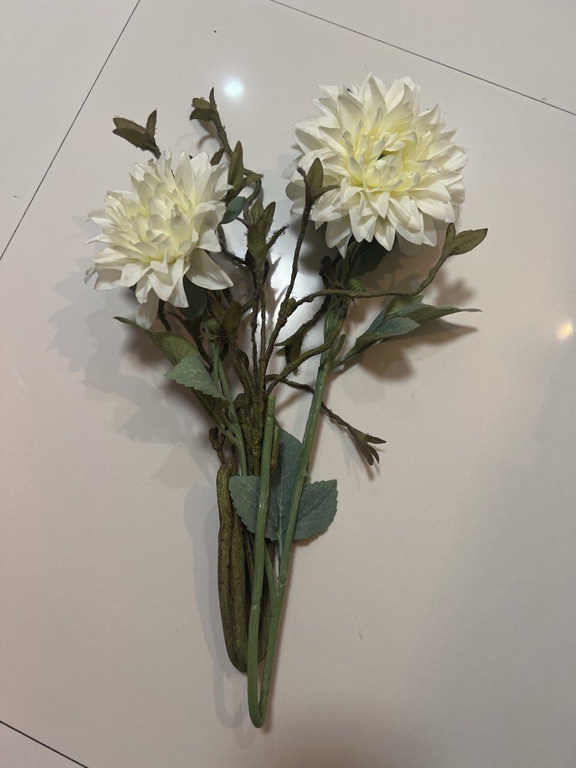 White Artificial Dahlia Flowers with Green Stems (Category: Artificial Plants & Flowers) located in Quezon City. Submitted by lucky876 (Listing ID 1460122475, Image 1). Description: - Two white dahlia-like artificial flowers - Realistic look and feel - Green stems and leaves, bundled together - Ideal for home decor and craft projects - Ready to be styled in a vase.